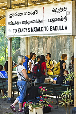 Foreign travellers await the popular Colombo to Badulla train at the railway station at Peradeniya, near Kandy, Sri Lanka, Asia