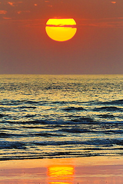 The sun setting off Playa Guiones surf beach, Nosara, Nicoya Peninsula, Guanacaste Province, Costa Rica, Central America