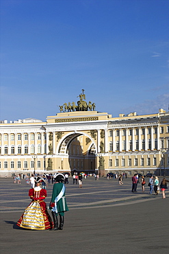 Costumed figures in Palace Square, and General Staff Building, Palace Square, St. Petersburg, Russia, Europe 