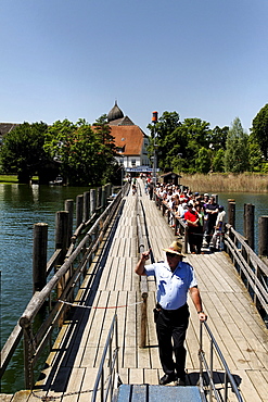 Tourists on the Fraueninsel pier waiting to board a ferry, lake Chiemsee, Chiemgau, Upper Bavaria, Germany, Europe