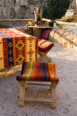 Turkish chairs and fireplace for boiling tea on a balcony, Ortahisar, Cappadocia, Anatolia, Turkey, Asia