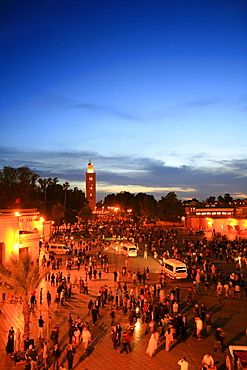 Koutoubia Mosque illuminated with red light, Djemaa el-Fna "Square of the Hanged Man" in the medina quarter of Marrakech at dusk with its countless food stalls, Marrakech, Morocco, Africa