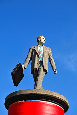 Businessman, sculpture on an advertising column, Duesseldorf, North Rhine-Westphalia, Germany, Europe