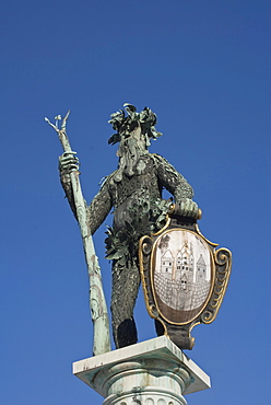 Bronze statue from the Neptune Fountain, a wild man bearing a trident and the coat of arms of Salzburg, Max-Reinhardt-Platz square, a UNESCO World Heritage Site, Salzburg, Austria, Europe