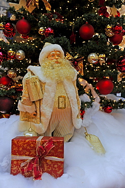 Christmas decoration, Santa Claus with gifts in front of a Christmas tree