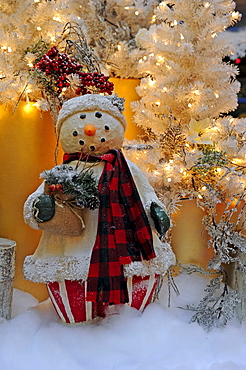 Christmas decorations, snowman in front of a Christmas tree