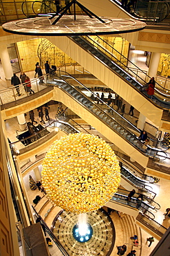 Christmas decorations, many small golden Christmas baubles make up one large Christmas bauble hanging in the staircase of a shopping centre, Essen, North Rhine-Westphalia, Germany, Europe