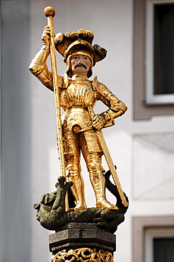 St. George and the dragon, golden fountain statue on Muensterplatz cathedral square, Freiburg im Breisgau, Baden-Wuerttemberg, Germany, Europe