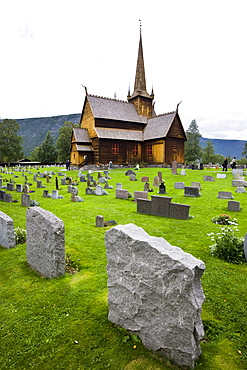 Grave stones in front of Lom Stave Church, Norway, Scandinavia, Europe