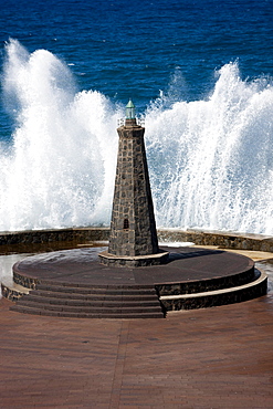 Waves behind a lighthouse on the Atlantic in Bajamar, Tenerife, Spain, Europe