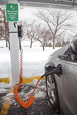 A Chevrolet Volt electric car charging outside the General Motors Detroit-Hamtramck Assembly Plant, where the Volt is manufactured, Detroit, Michigan, USA