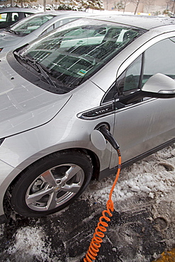 A Chevrolet Volt electric car charging outside the General Motors Detroit-Hamtramck Assembly Plant, where the Volt is manufactured, Detroit, Michigan, USA