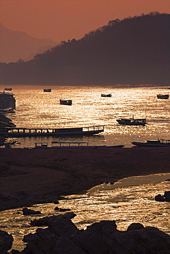 A sunset scene over the Mekong river where it meets the Nam Khan river, Luang Prabang, Laos, Southeast Asia