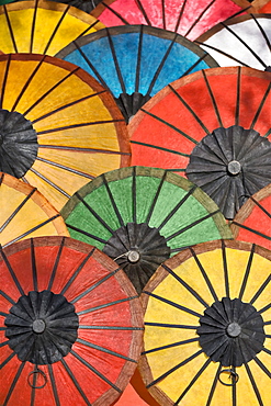 Multicoloured hand made paper umbrellas or parasols on sale at the handicraft evening market in Luang Prabang, Laos, Southeast Asia