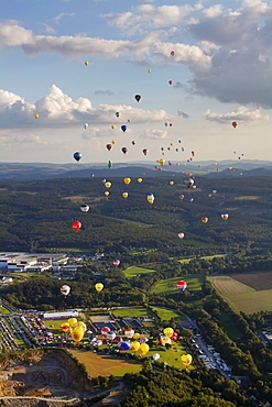 Aerial view, 20th Warsteiner Montgolfiade, hot-air-balloon festival with nearly 200 hot-air-balloons ascending into the sky, Warstein, Sauerland, North Rhine-Westphalia, Germany, Europe