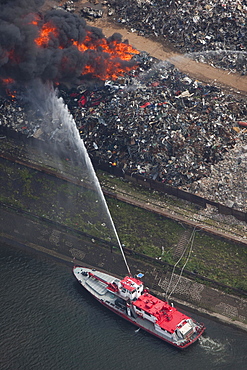 Aerial view, smoke, fire on a scrap island in the Duisport inland port, Duisburg, Ruhrgebiet region, North Rhine-Westphalia, Germany, Europe