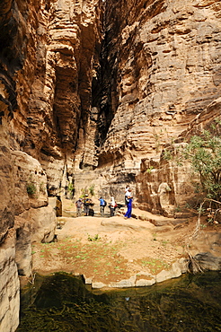 Tourists at the guelta in the slot canyon of Wadi Essendilene, Tassili n'Ajjer National Park, Unesco World Heritage Site, Wilaya Illizi, Algeria, Sahara, North Africa