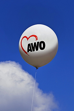 Balloon with an AWO logo against a blue sky with a cloud, AWO, worker's welfare organisation