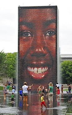 Children having fun with the water fountains of Crown Fountain, Millennium Park, Chicago, Illinois, United States of America, USA