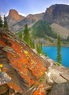 Moraine Lake, colored lichen on rock, Wenkchemna Range Mountains, Valley of the Ten Peaks, Banff National Park, Canadian Rocky Mountains, Alberta, Canada