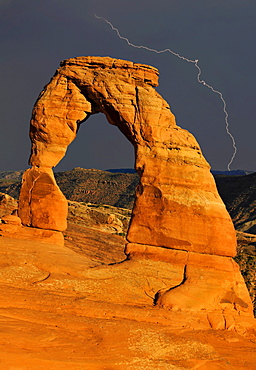 Delicate Arch, a natural stone arch, during a thunderstorm with lightning, Arches National Park, Moab, Utah, Southwest, United States of America, USA