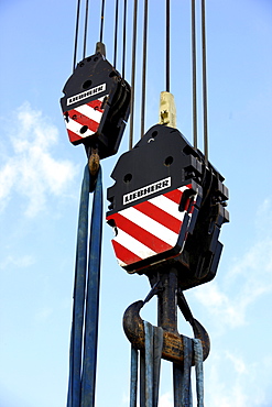 Crane hooks of a large mobile crane with rope loops to secure loads