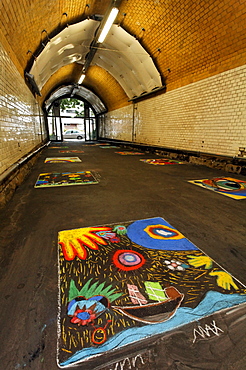 Pedestrian tunnel with chalk drawings on the ground, painted by children, disused Suedbahnhof railway station, Krefeld, North Rhine-Westphalia, Germany, Europe