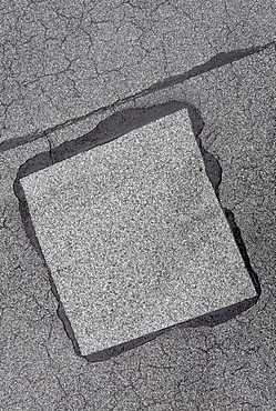 Patched-up, repaired area on a roof made of roofing felt