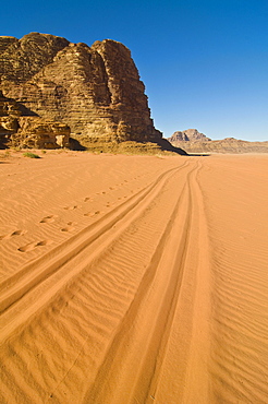 Tyre tracks leading into the desert, Wadi Rum, Jordan, Western Asia