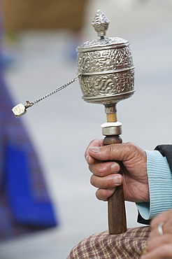 Buddhist pilgrim holding a prayer wheel, Thimpu, Bhutan, Asia