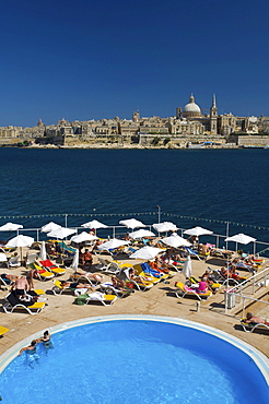 View from a hotel pool in Sliema towards Valletta, Malta, Europe