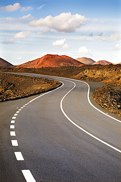 Road through a volcanic landscape near the Timanfaya National Park, Lanzarote, Canary Islands, Spain, Europe