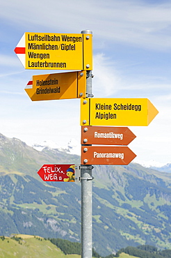 Signpost for hikers on Maennlichen Mountain in the Bernese Alps, Canton of Bern, Switzerland, Europe