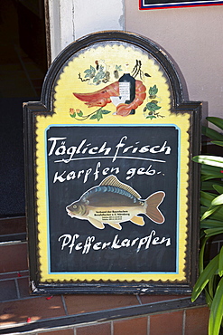 Menu board offering fresh carp, Germany