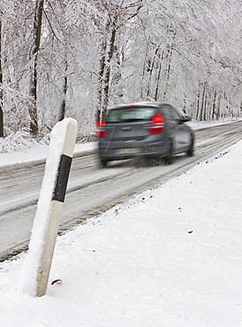 Snow-covered road in winter with traffic, Hesse, Germany, Europe