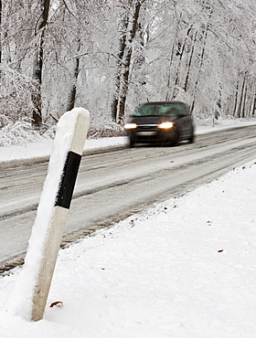 Snow-covered road in winter with traffic, Hesse, Germany, Europe