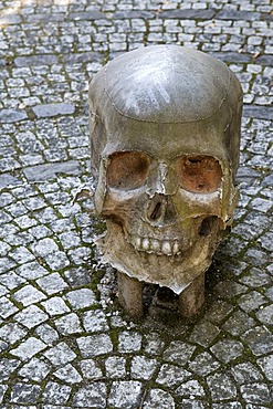 Sculpture of a skull in a churchyard in Wangen, Allgaeu, Baden-Wuerttemberg, Germany, Europe