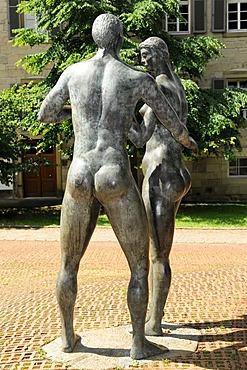 Sculptures of Adam and Eve in front of the Spitalmuehle mill, courtyard of the 'Heiliger Geist' Hospital, Schwaebisch Gmuend, Baden-Wuerttemberg, Germany, Europe