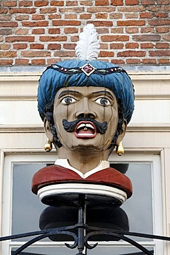 Bust of a man wearing a turban with a pill on the tongue, historic store sign of a pharmacy, Goes, Zeeland province, Netherlands, Benelux, Europe