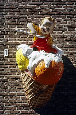 Child with spoon sitting on an ice-cream cone, advertising character on an ice cream parlor, Veere, Walcheren, Zeeland, Netherlands, Benelux, Europe