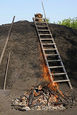 Charcoal kiln is set on fire by charburner, Walpersdorf, Siegen-Wittgenstein, North Rhine-Westphalia, Germany