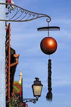 Sign outside a hairdresser's shop, comb and plait hanging from a ball, 18 Grand'Rue, Ribeauville, Alsace, France, Europe