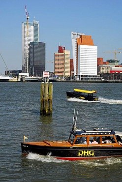 Small watertaxi ferry boats on the Nieuwe Maas River, modern architecture at the Wilhelminapier at back, Rotterdam, Zuid-Holland, South-Holland, Netherlands, Europe