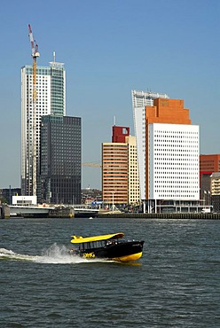 Small watertaxi ferry boat on the Nieuwe Maas River, modern architecture at the Wilhelminapier at back, Rotterdam, Zuid-Holland, South-Holland, Netherlands, Europe