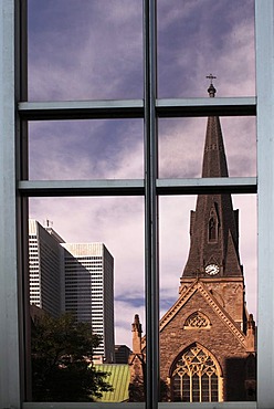 Church reflected in the facade of a high-rise building, Montreal, Quebec, Canada