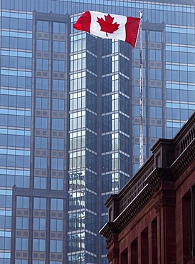 Canadian national flag in front of skyscraper, Montreal, Quebec, Canada