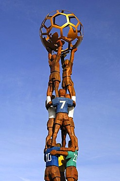 Football monument in the form of a pyramid of football players, holding a globe in front of the Home of FIFA, headquarters of the international governing body of association football, Zurich, Switzerland, Europe