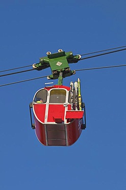 Red cabin of the Kampenwandbahn ropeway with skis on the outside of the cabin, ascend to the mountain, Chiemgau, Bavaria, Germany, Europe