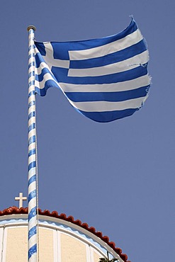 Fluttering Greek flag, Olympos, Karpathos island, Aegean Islands, Aegean Sea, Dodecanese, Greece, Europe