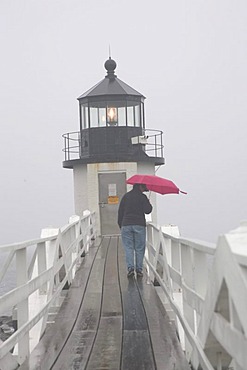 Marshall Point lighthouse, woman, red umbrella, rain, fog, Port Clyde, Maine, New England, USA